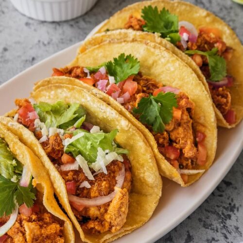 Crispy Baked Chicken Tacos stuffed with spiced ground chicken, melted cheese, and a zesty kick of lime and cilantro. Perfect for taco night with a fun crunch!