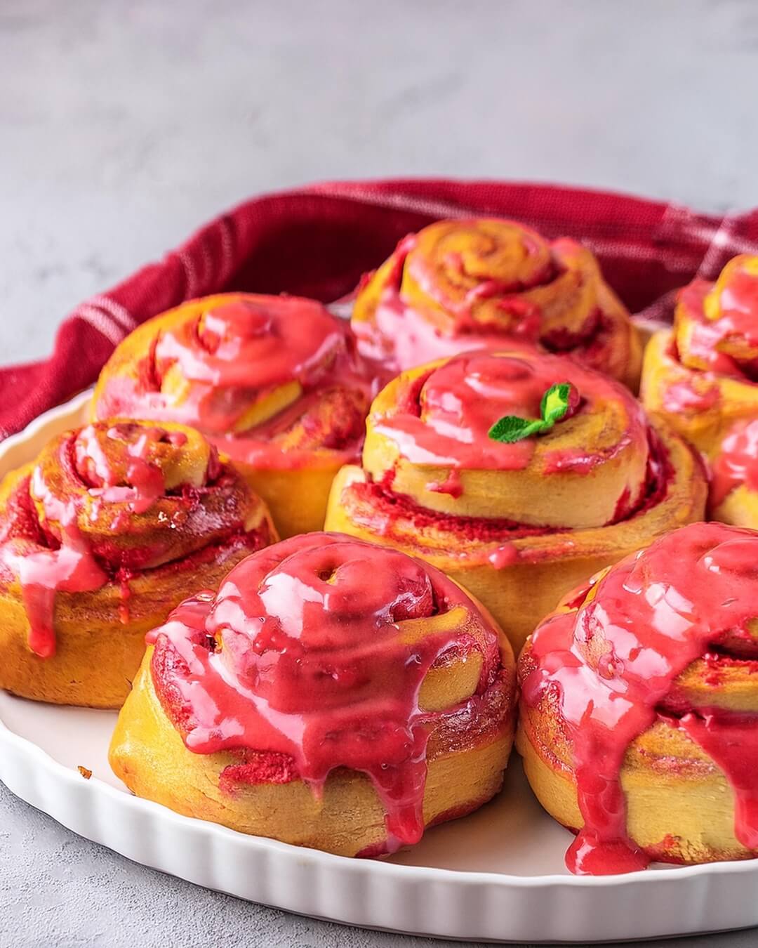 These Strawberry Rolls are a delightful treat combining soft, fluffy dough with a creamy strawberry and white chocolate filling, topped with a fresh strawberry glaze. The tangzhong roux ensures the dough stays moist and tender, while the roasted strawberry puree intensifies the flavor. A perfect balance of sweetness, richness, and fruitiness in every bite!